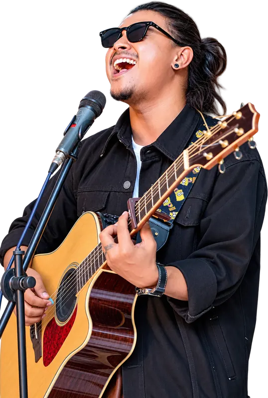 Kuma Sagar singing on stage with an acoustic guitar